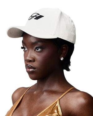 Cream-colored cotton cap with a bold logo detail, suitable for everyday wear.