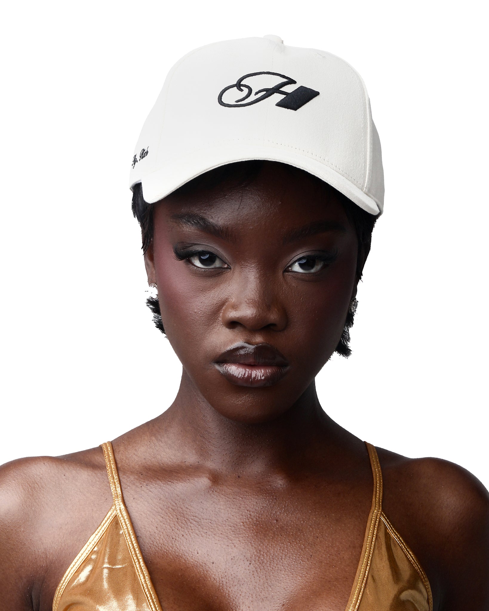 A cream-colored cotton cap with a logo embroidered on the front.